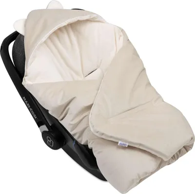 A baby car seat with a cream-colored plush cover with a hood and ears.