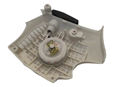 A white plastic starter assembly for a chainsaw.