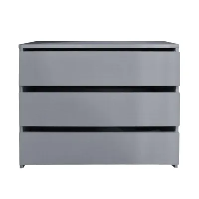 A grey chest of drawers with three drawers.
