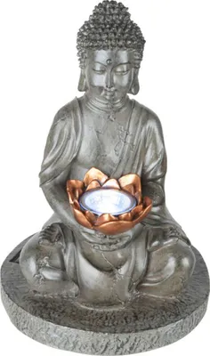 A statue of Buddha holding a lotus flower with a light inside.
