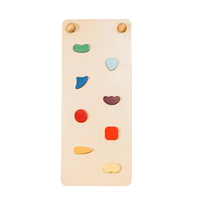 A wooden climbing board with colorful grips against a white background.