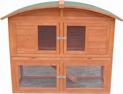 A two-tiered wooden rabbit hutch with a green roof.