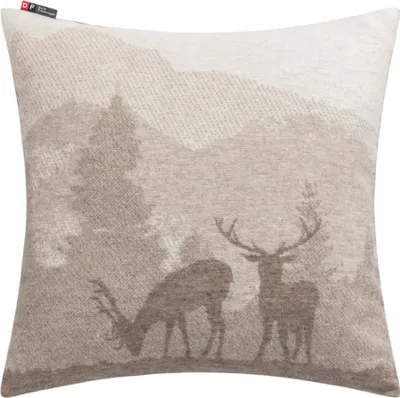 A pillow with a landscape scene featuring deer and mountains.