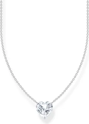 A close-up studio shot of a silver necklace with a heart-shaped diamond pendant on a white background.