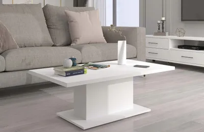 A modern living room scene with a white coffee table in the foreground, a grey sofa in the background, and a white media console with drawers and a shelf.