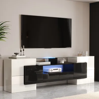 A modern TV stand with a large flat-screen TV mounted above it.