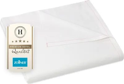 A folded white bedsheet with a product label on the left.