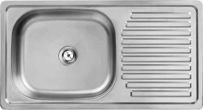 A top-down view of a stainless steel kitchen sink with a drainboard.