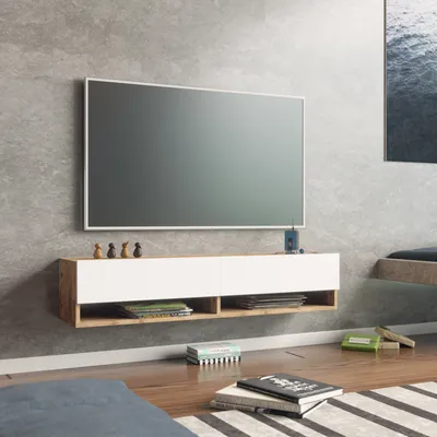 A modern living room with a wall-mounted TV stand and television.