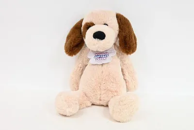 A plush dog toy sitting on a white background.