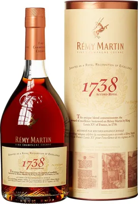 A bottle of Remy Martin 1738 Accord Royal Cognac and its cylindrical presentation box.