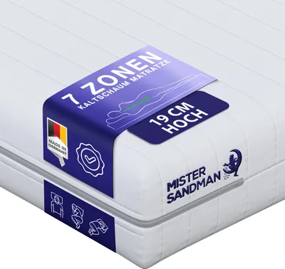 A close-up view of a mattress with a marketing tag attached.