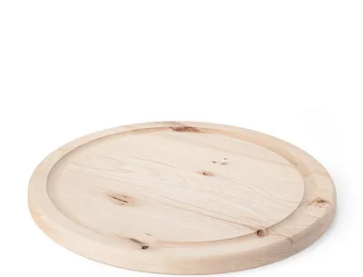 A round wooden cutting board with a groove around the edge, placed on a white background.