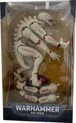 A Warhammer 40,000 action figure of a Tyranid Genestealer in its original packaging.