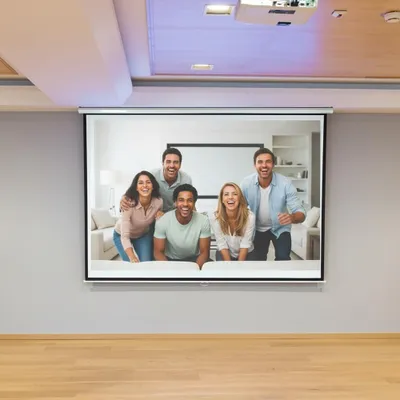 A group of five friends are posing for a photo in front of a projector screen.