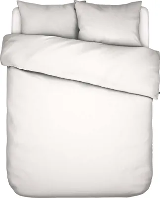 A top-down view of a white duvet cover and two white pillowcases neatly arranged on a bed.