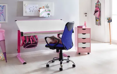 A child's desk and chair setup in a room.