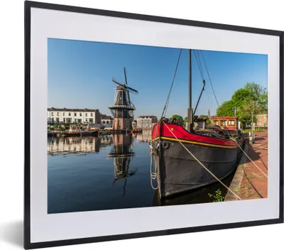 Produktbild von MuchoWow® MuchoWow® Gerahmtes Poster Haarlem - Boot - Mühle 40x30 cm - Poster mit zchwarzem Bilderrahmen - Bilderrahmen - Poster im Rahmen