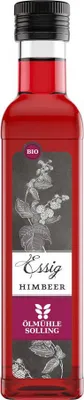 A bottle of raspberry vinegar with a label featuring botanical illustrations and text.