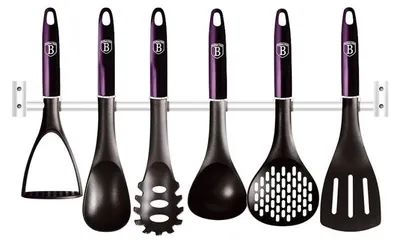 A set of kitchen utensils hanging on a wall rack.