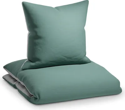 A teal duvet cover and pillow are neatly folded and stacked on a white background.