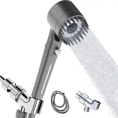 A modern gray shower head with water spraying from it, shown with accessories on a white background.