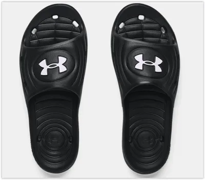 A pair of black Under Armour slides shown from a top-down view against a white background.