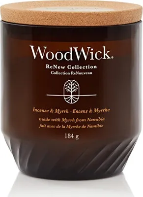 A close-up studio shot of a WoodWick candle in a brown glass jar with a cork lid.