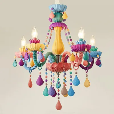A colorful, whimsical chandelier with multiple candle-style lights and decorative hanging elements.