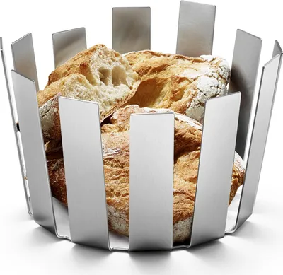 A stainless steel bread basket filled with loaves of bread.