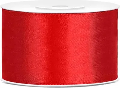 A roll of red satin ribbon on a white spool.