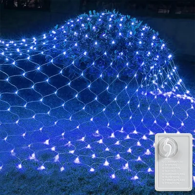 A net of blue LED lights draped over a bush and on the ground.