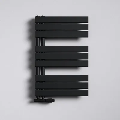 A black radiator mounted on a white wall.