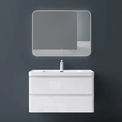 A white bathroom vanity with a sink and faucet is mounted on a dark gray wall, with a backlit mirror above it.