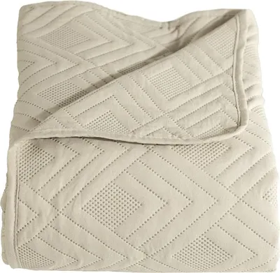 A folded beige blanket with a geometric pattern.
