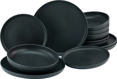 A set of black stoneware plates and bowls are arranged on a white background.