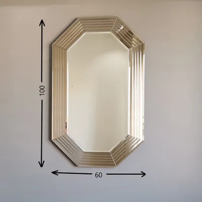 A mirror hanging on a wall with dimensions indicated by arrows and numbers.