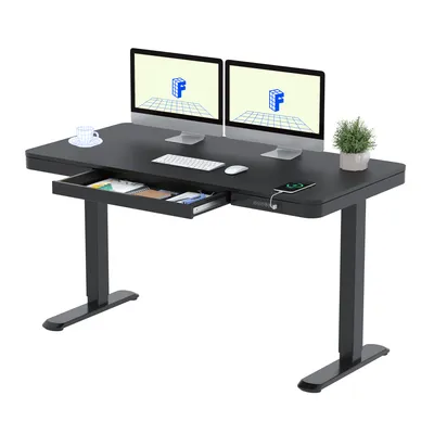 A black electric height-adjustable desk with two monitors, a keyboard, a mouse, a cup, a plant, and an open drawer.