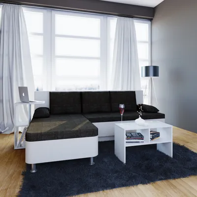 A modern living room with a sectional sofa, coffee table, and large window.
