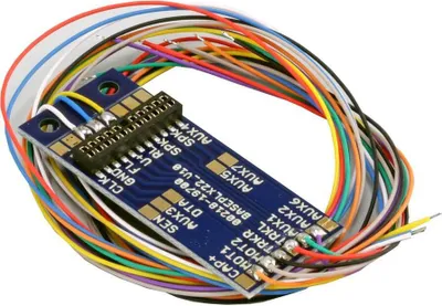 A close-up, angled view of a blue circuit board with many colorful wires attached.