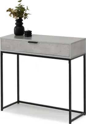 A console table with a drawer and a black metal frame, decorated with a vase of flowers and a candle.