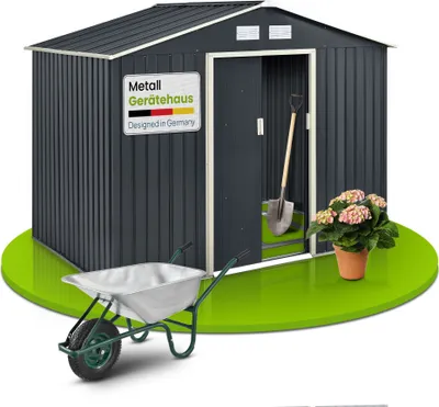 A metal garden shed with a wheelbarrow and a potted plant in front of it, set against a green circular base.