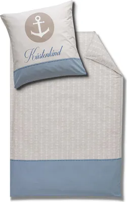 A pillow and a duvet cover with a nautical theme, featuring an anchor design and the text 'Küstenkind'.