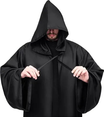 A person wearing a black hooded robe, tying the front closure.