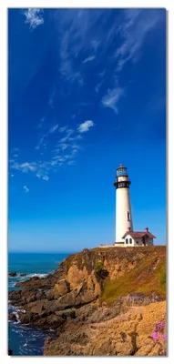 Produktbild von Wallario selbstklebende Türtapete 100 x 220 cm - Leuchtturm auf einem Felsvorsprung - Blauer Himmel - Abwischbar, rückstandsfrei zu entfernen