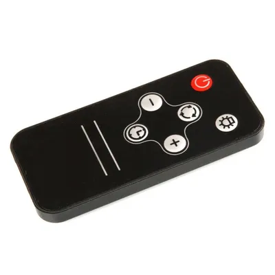 A black remote control with silver buttons, viewed from a slightly elevated angle.