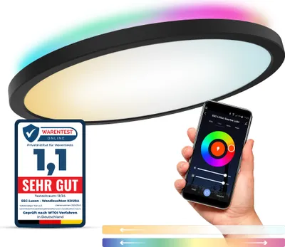 A hand holding a smartphone displaying a smart light app, with a ceiling light in the background emitting colorful light. A quality seal is also visible.