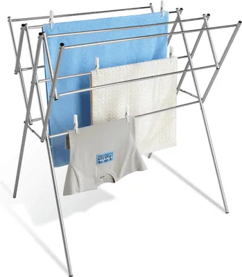 A freestanding, collapsible stainless steel drying rack with laundry items hanging on it.