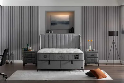A bedroom setting with a bed, nightstands, and a floor lamp.