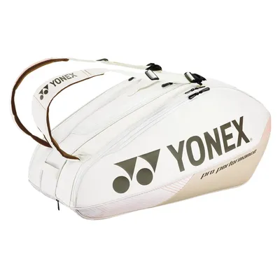 A white and beige Yonex tennis bag with brown handles is shown against a white background.